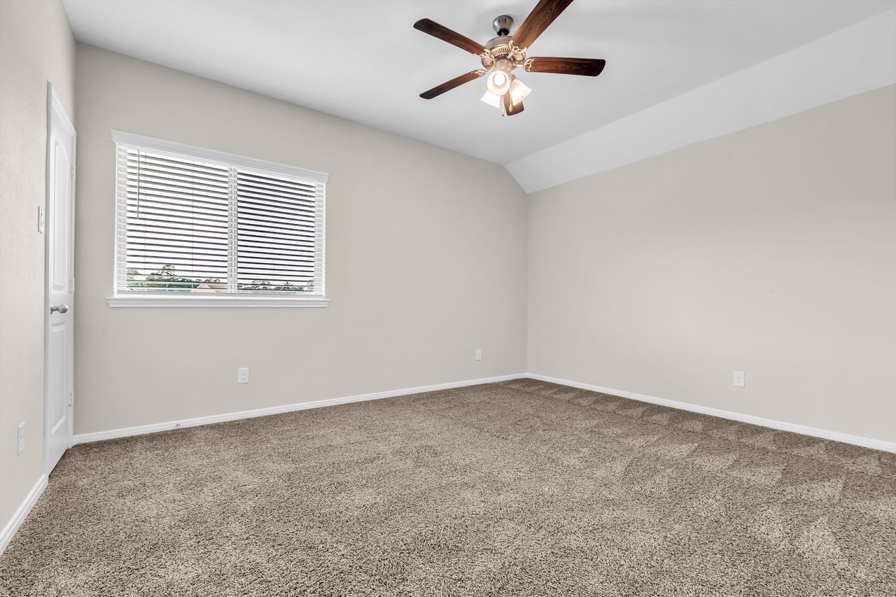 14304 Prospect Park Lane Conroe, TX 77384 - Photo 29 of 38 an empty room with a window and a fan