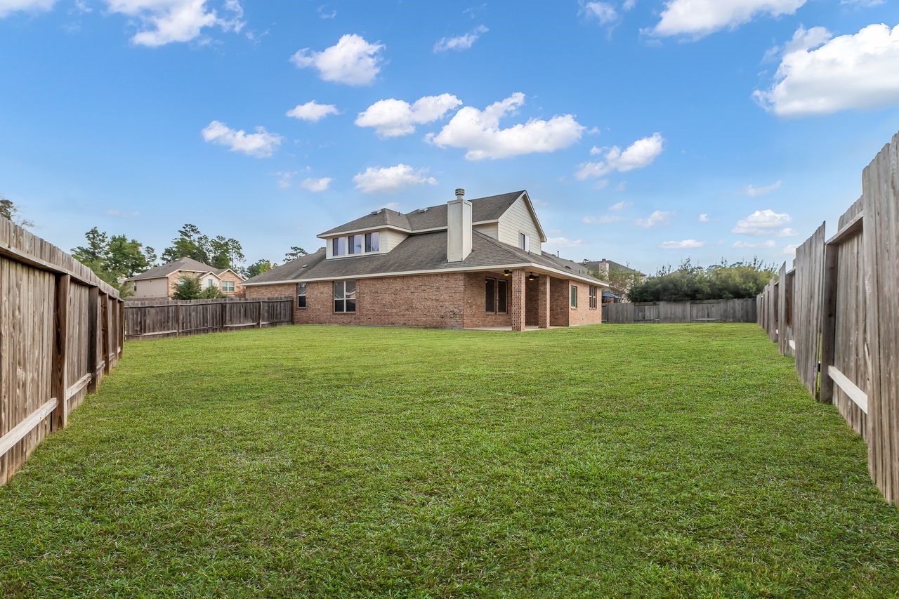 14304 Prospect Park Lane Conroe, TX 77384 - Photo 36 of 38 a front view of a house with garden