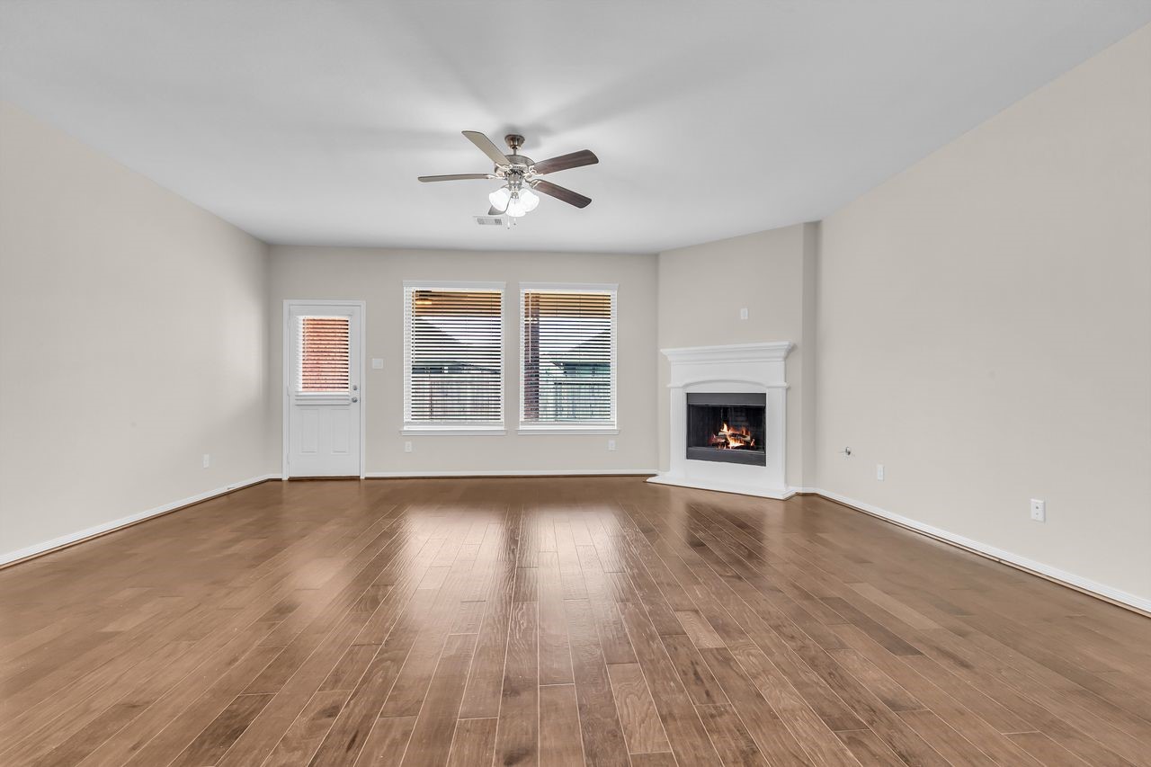 14304 Prospect Park Lane Conroe, TX 77384 - Photo 5 of 38 a view of an empty room with wooden floor and a window