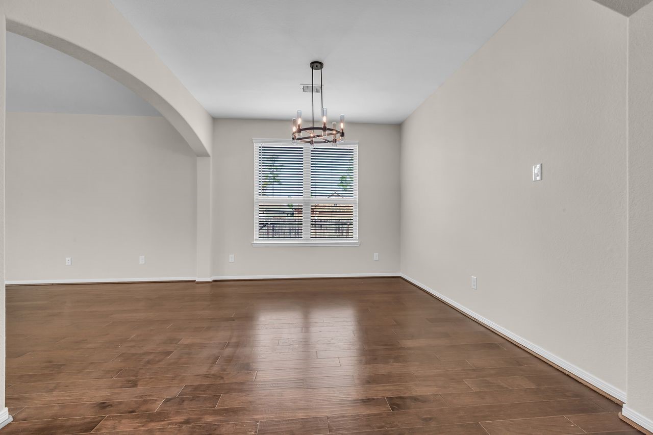 14304 Prospect Park Lane Conroe, TX 77384 - Photo 7 of 38 wooden floor in an empty room with a window