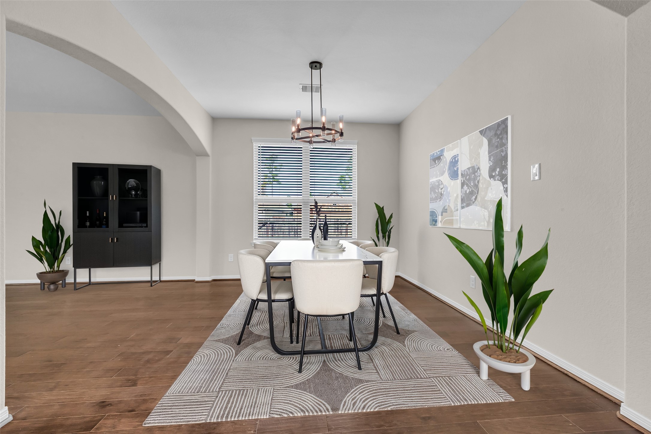 14304 Prospect Park Lane Conroe, TX 77384 - Photo 8 of 38 a dining room with furniture potted plants and wooden floor