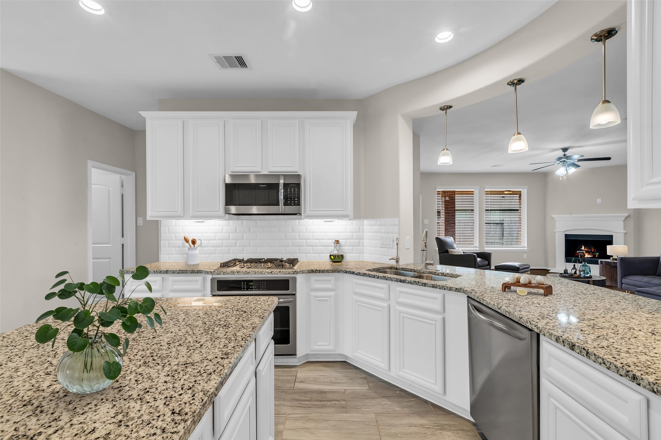 14304 Prospect Park Lane Conroe, TX 77384 - Photo 10 of 38 a kitchen with a sink stove and cabinets