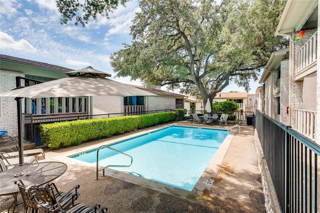 a view of a house with pool and chairs