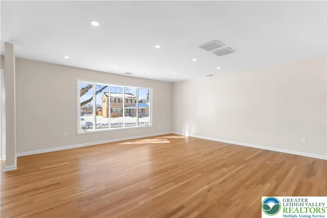 a kitchen with stainless steel appliances kitchen island wooden cabinets and entryway