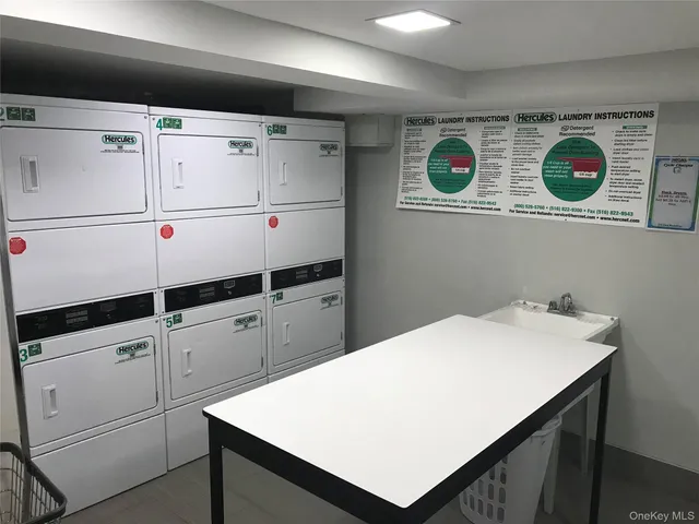 a kitchen with kitchen island white cabinets and white appliances