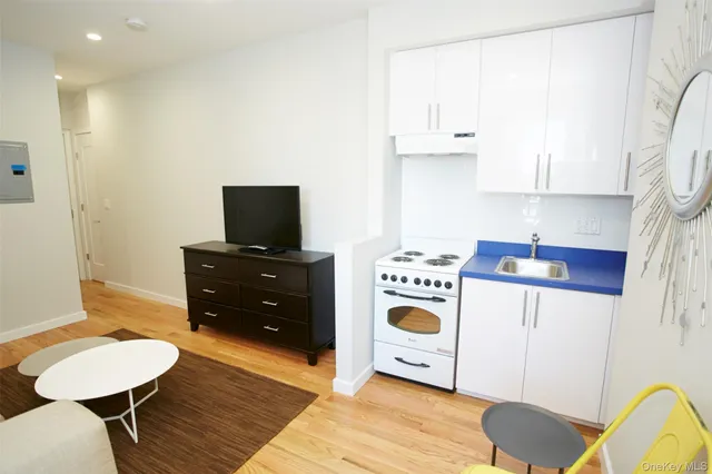 a kitchen with a stove a refrigerator and a table