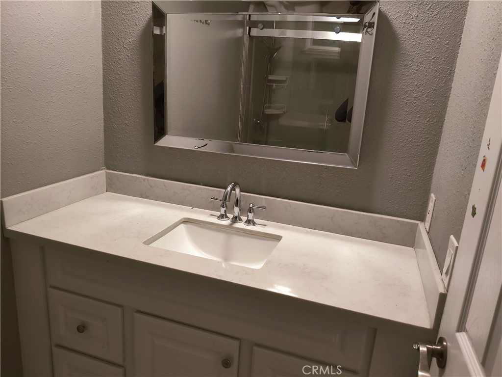 1806 Morning Canyon Road Diamond Bar, CA 91765 - Photo 12 of 16 a bathroom with a sink vanity and a mirror