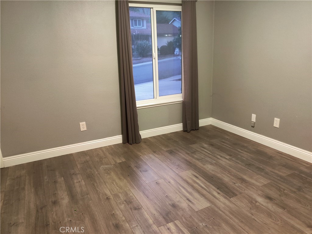 1806 Morning Canyon Road Diamond Bar, CA 91765 - Photo 14 of 16 an empty room with wooden floor and windows