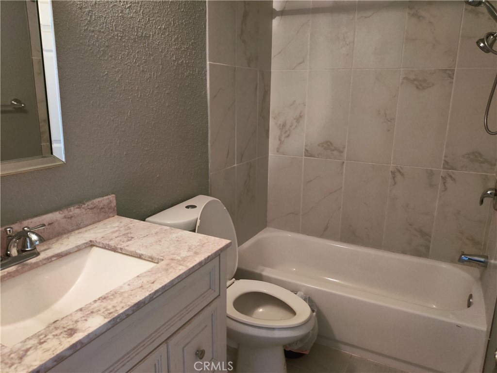 1806 Morning Canyon Road Diamond Bar, CA 91765 - Photo 15 of 16 a bathroom with a granite countertop sink a toilet and bathtub