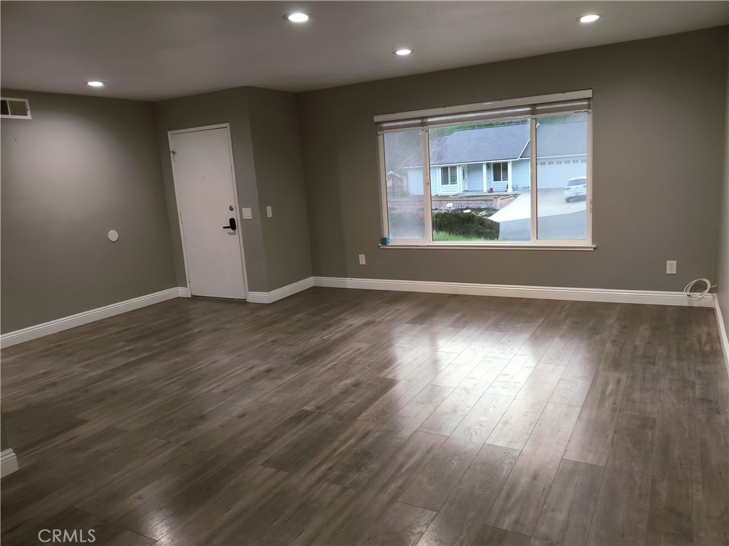 1806 Morning Canyon Road Diamond Bar, CA 91765 - Photo 2 of 16 an empty room with wooden floor and windows