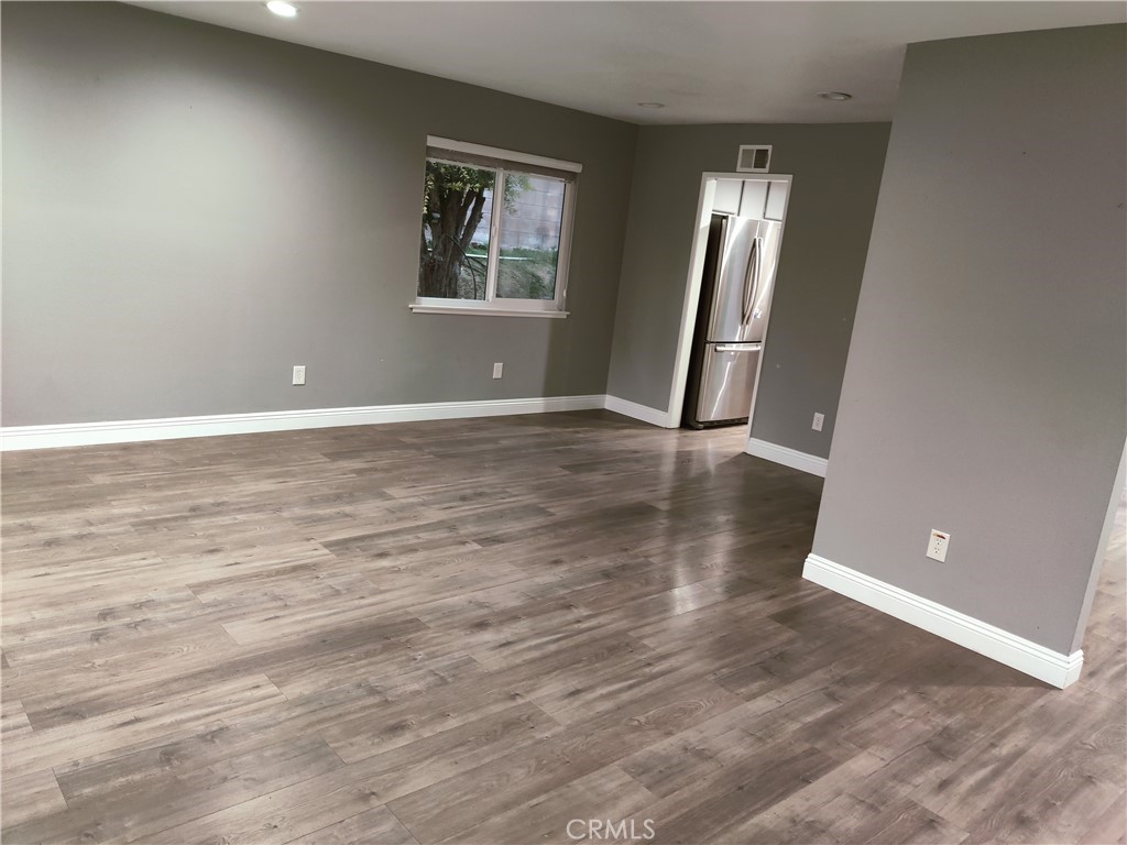 1806 Morning Canyon Road Diamond Bar, CA 91765 - Photo 5 of 16 an empty room with wooden floor and windows