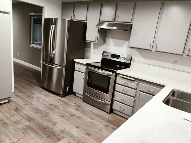 a kitchen with stainless steel appliances a refrigerator a stove and a sink