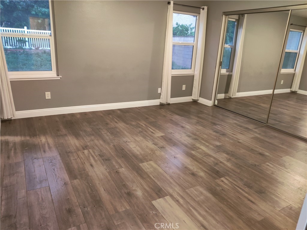 1806 Morning Canyon Road Diamond Bar, CA 91765 - Photo 10 of 16 an empty room with wooden floor and windows