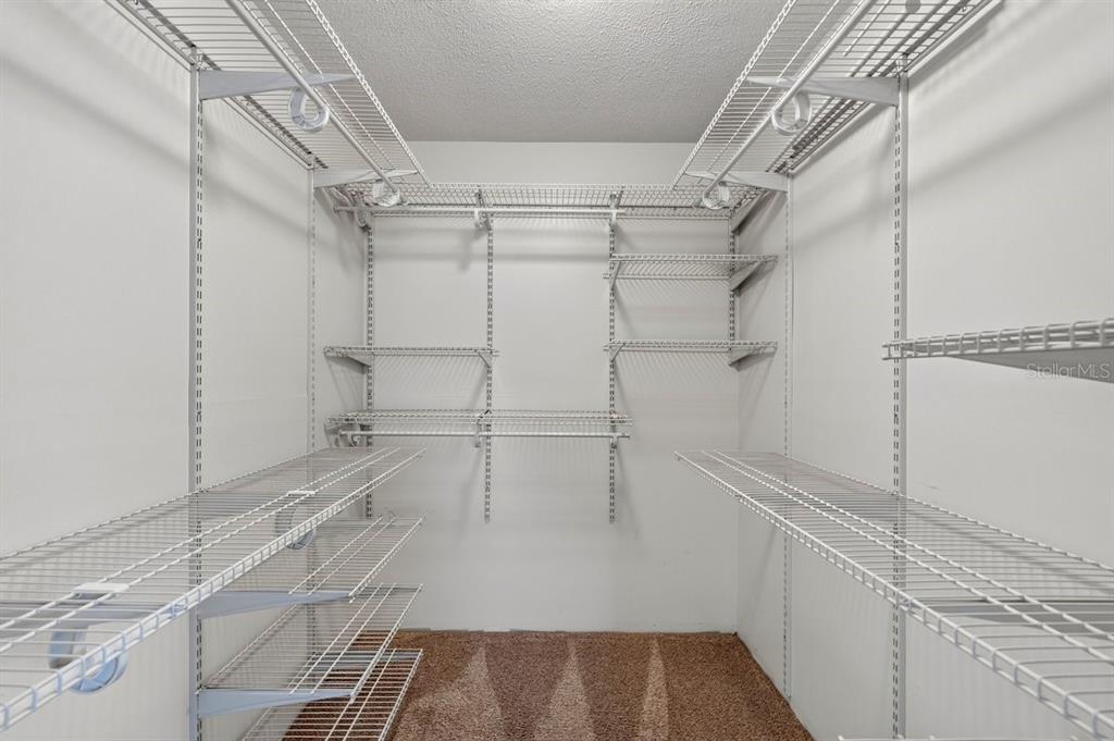1309 Suwanee Road Daytona Beach, FL 32114 - Photo 17 of 33 a view of walk in closet with empty racks