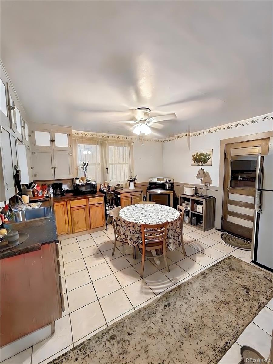 3935 Shoshone Street Denver, CO 80211 - Photo 13 of 14 a large kitchen with a large counter top space a sink stainless steel appliances and cabinets