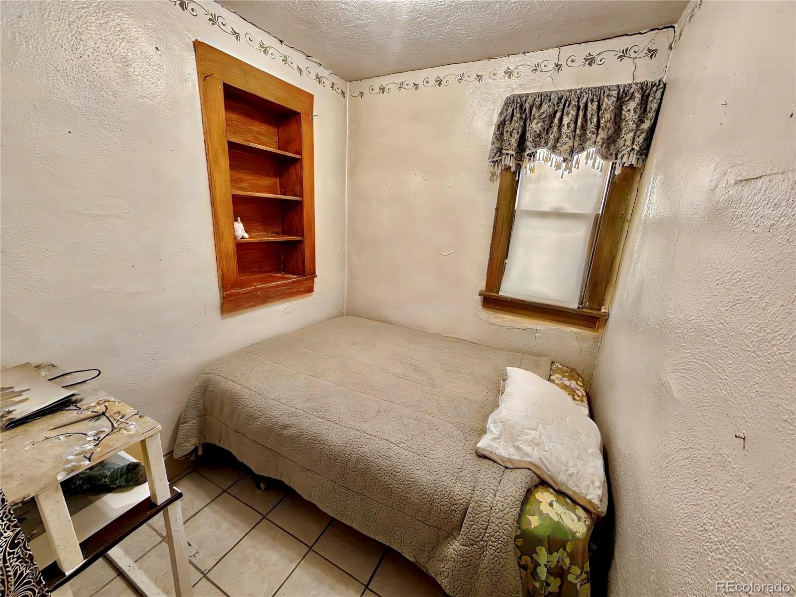 3935 Shoshone Street Denver, CO 80211 - Photo 14 of 14 a bedroom with a bed and a window