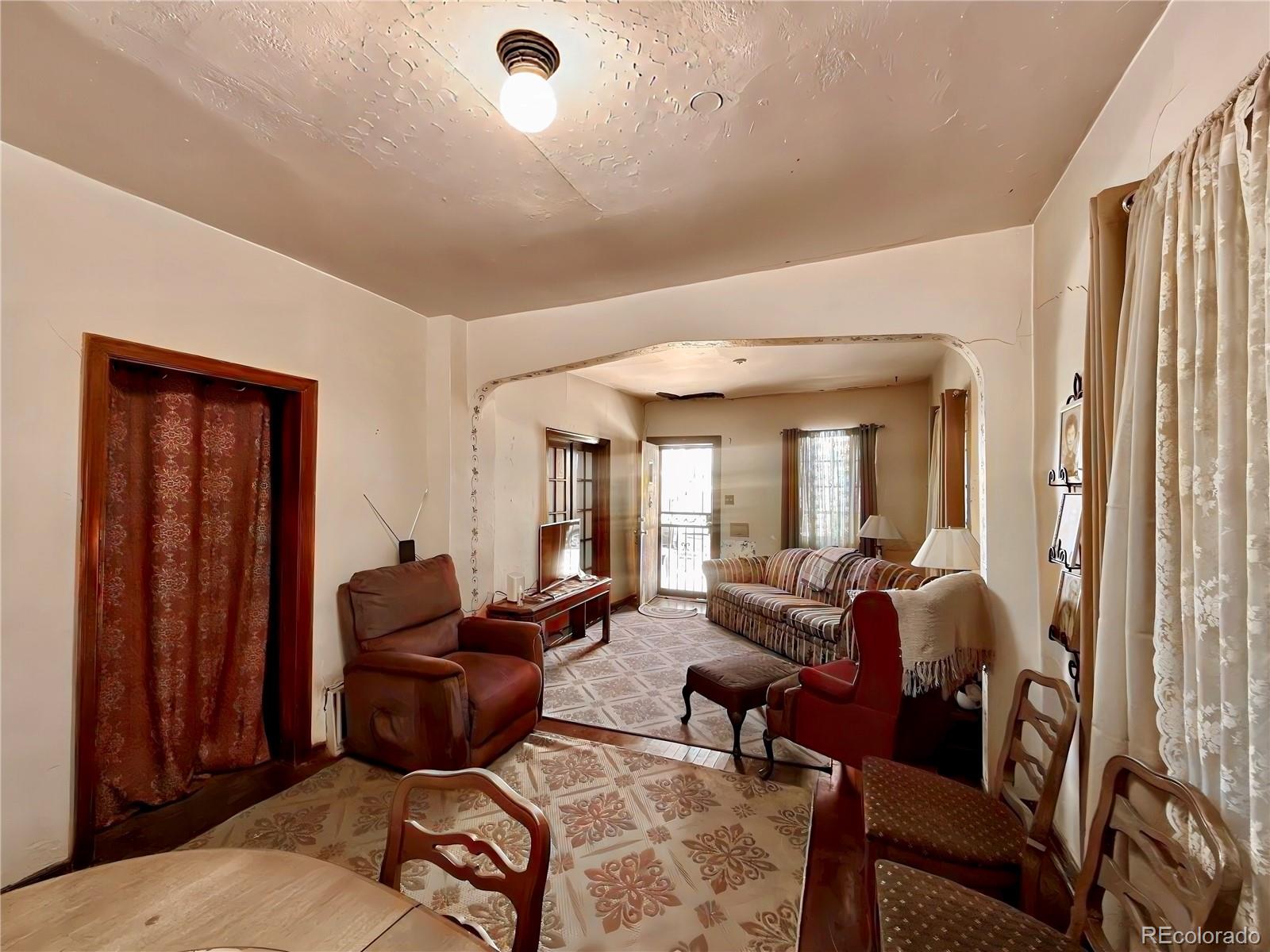 3935 Shoshone Street Denver, CO 80211 - Photo 9 of 14 a living room with furniture and a window