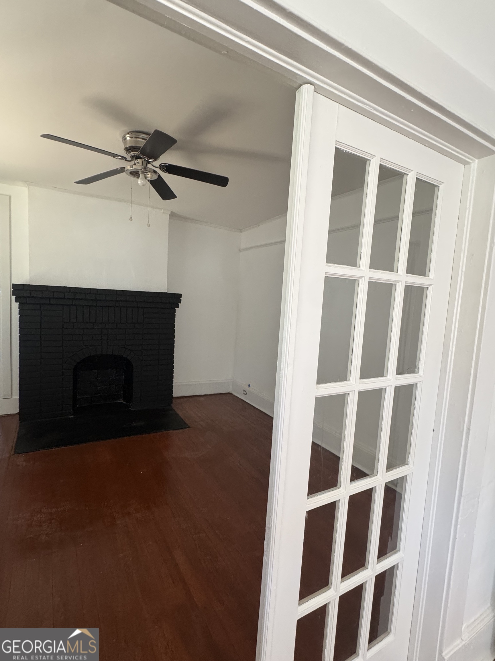 415 Hopkins Street Southwest Atlanta, GA 30310 - Photo 11 of 12 a view of an empty room with a fireplace and a window