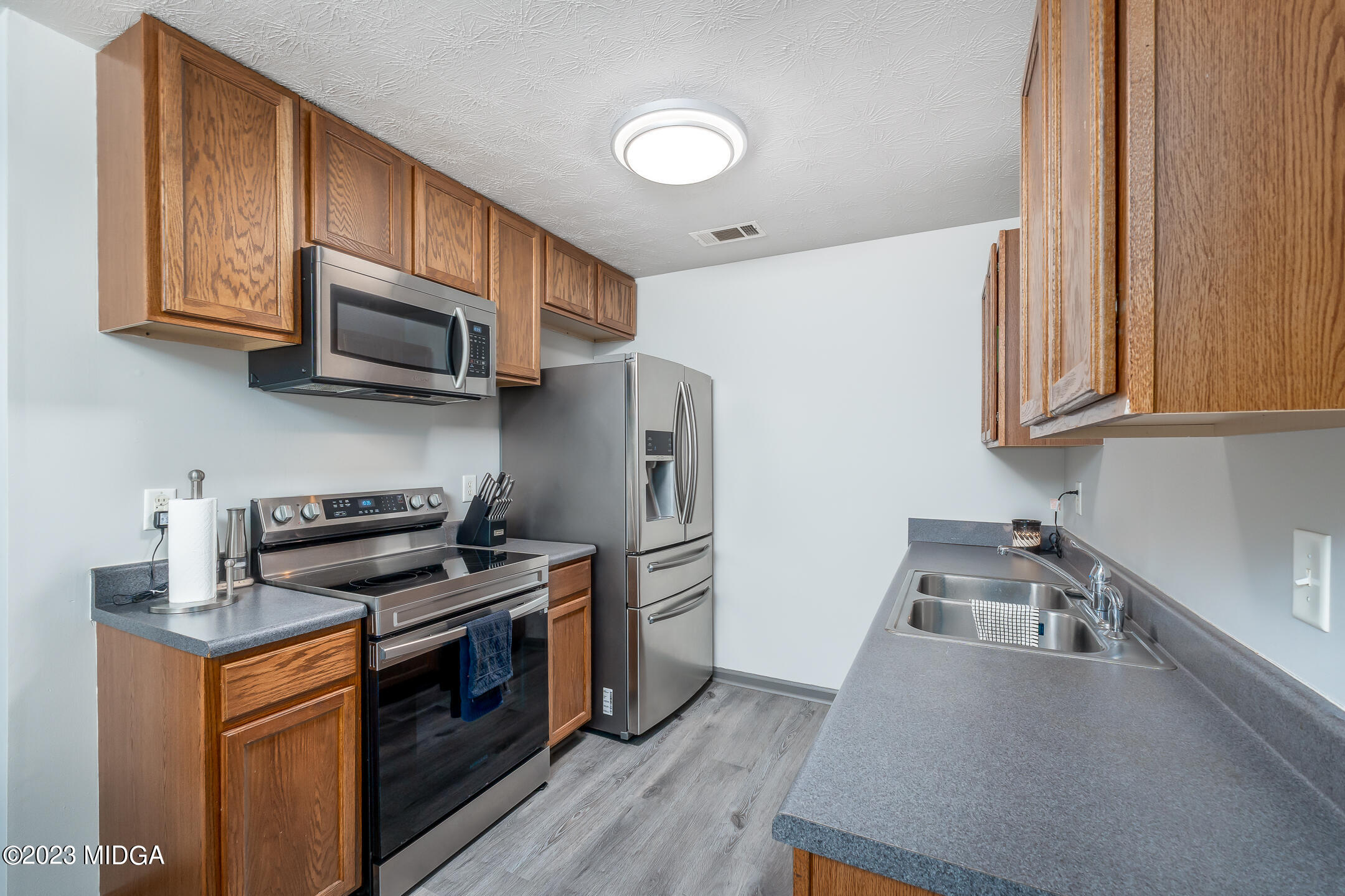 128 Samuel Barber Road Jackson, GA 30233 - Photo 13 of 27 a kitchen with stainless steel appliances a stove microwave and sink