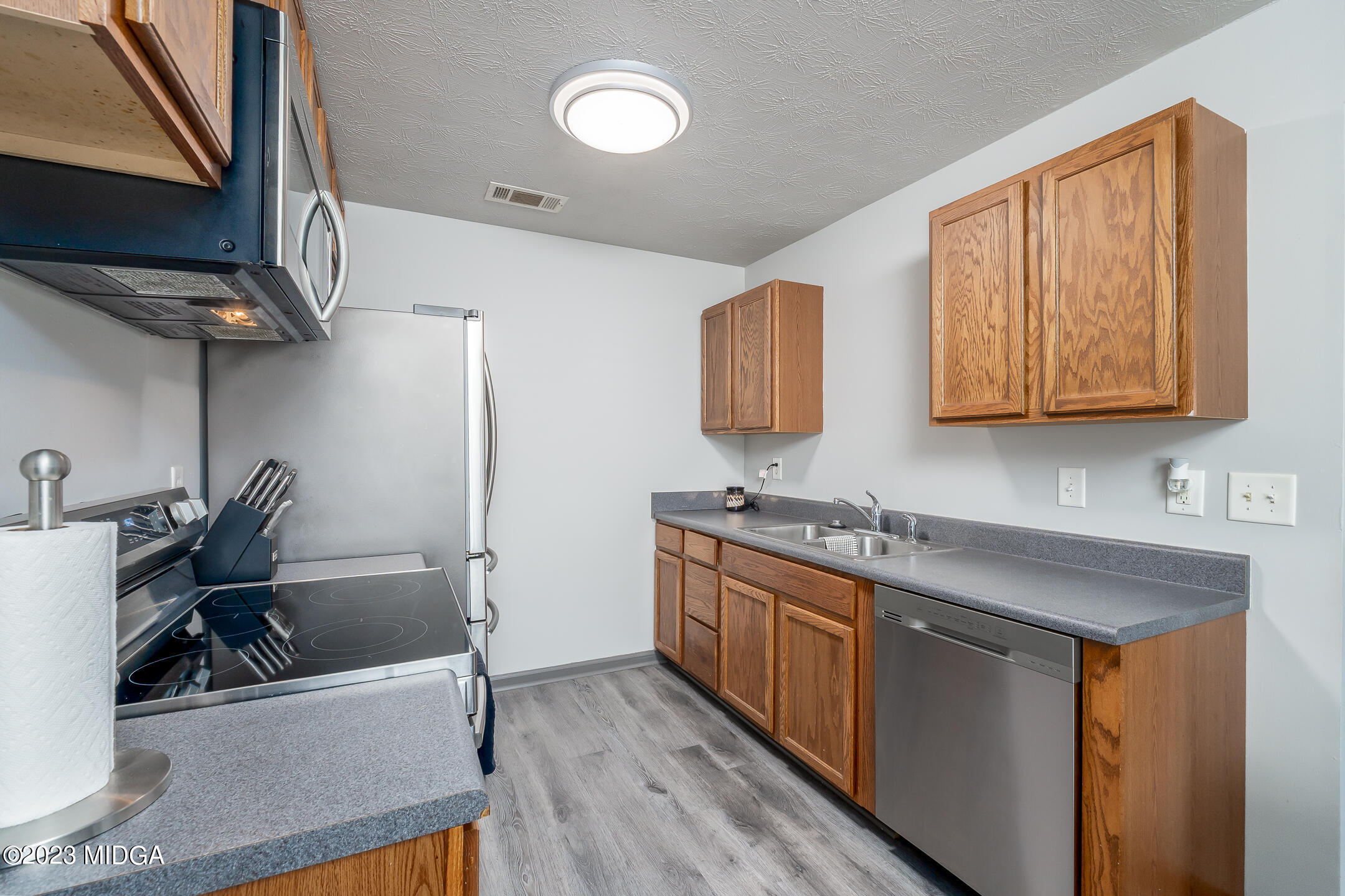 128 Samuel Barber Road Jackson, GA 30233 - Photo 14 of 27 a kitchen with stainless steel appliances granite countertop a sink stove and refrigerator