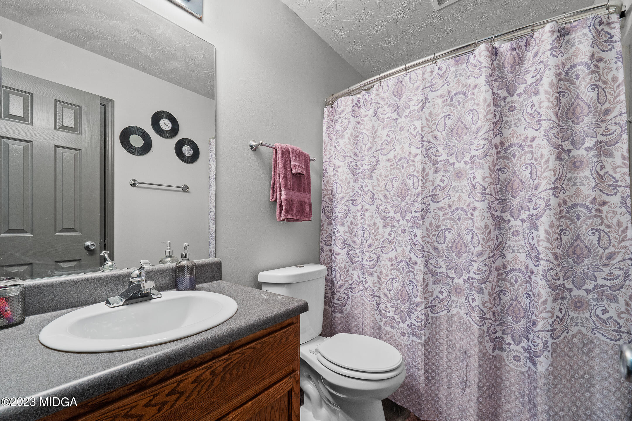128 Samuel Barber Road Jackson, GA 30233 - Photo 21 of 27 a bathroom with a toilet sink and mirror