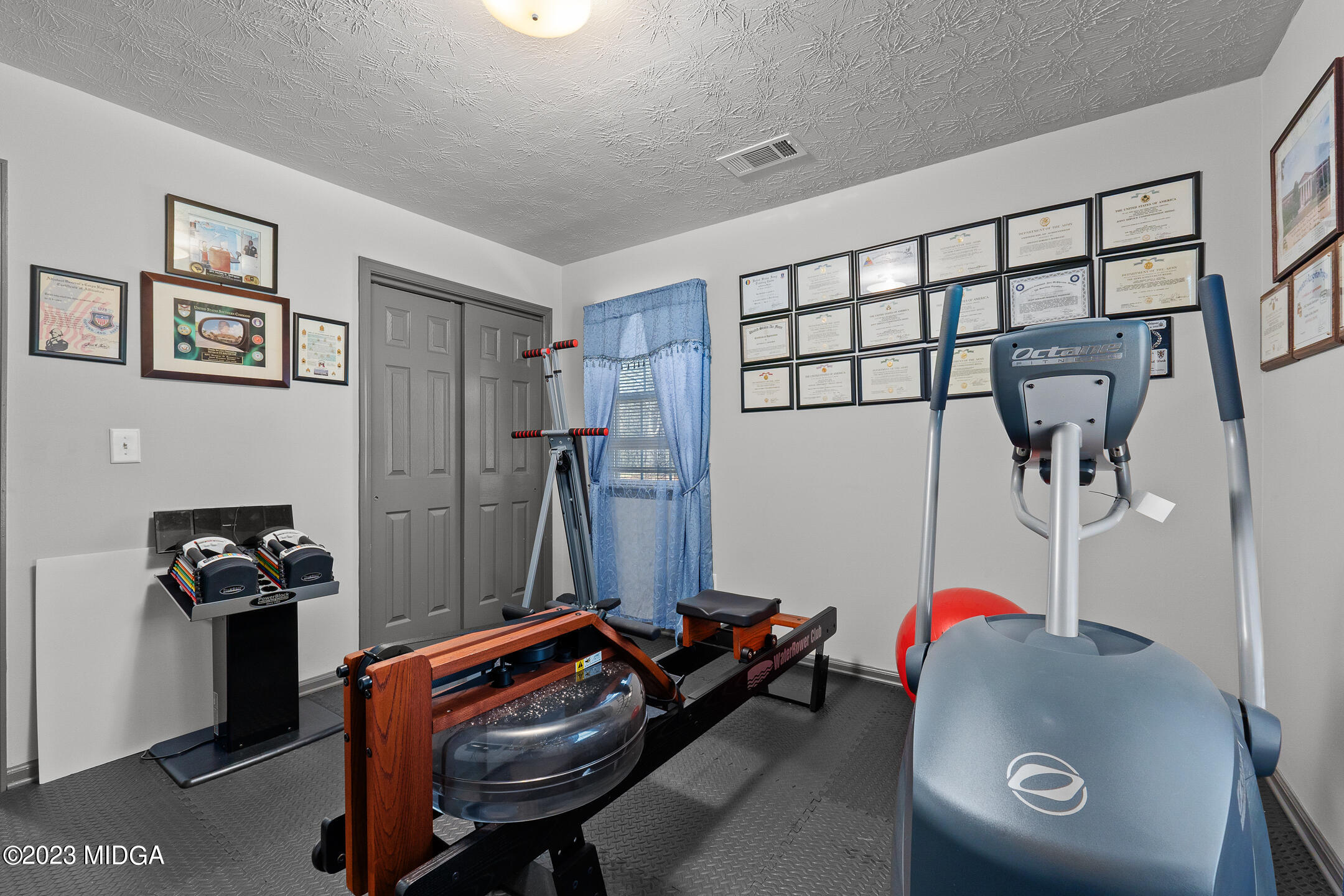 128 Samuel Barber Road Jackson, GA 30233 - Photo 22 of 27 a room with furniture and gym equipment