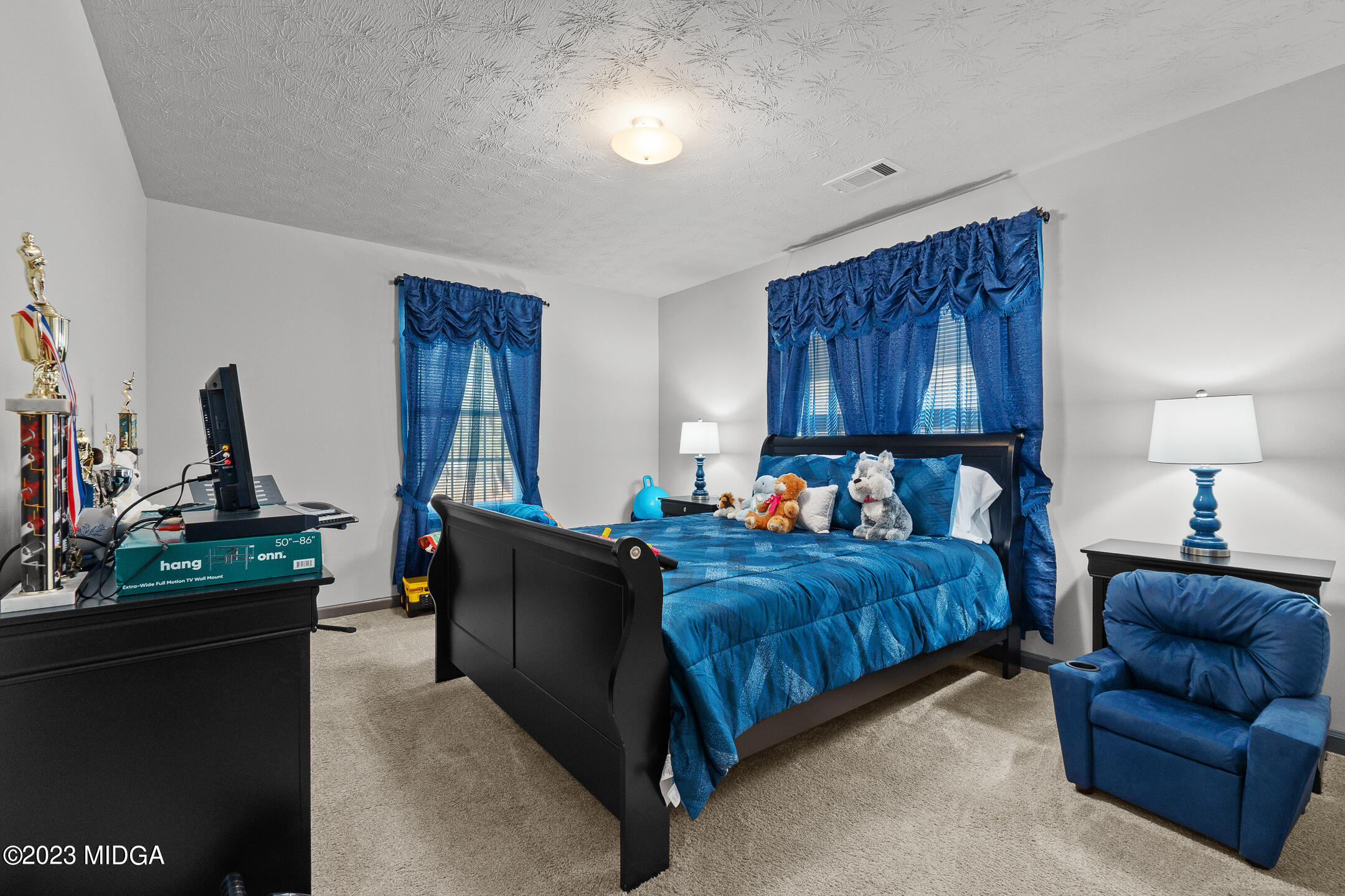 128 Samuel Barber Road Jackson, GA 30233 - Photo 23 of 27 a bed room with a bed and a couch