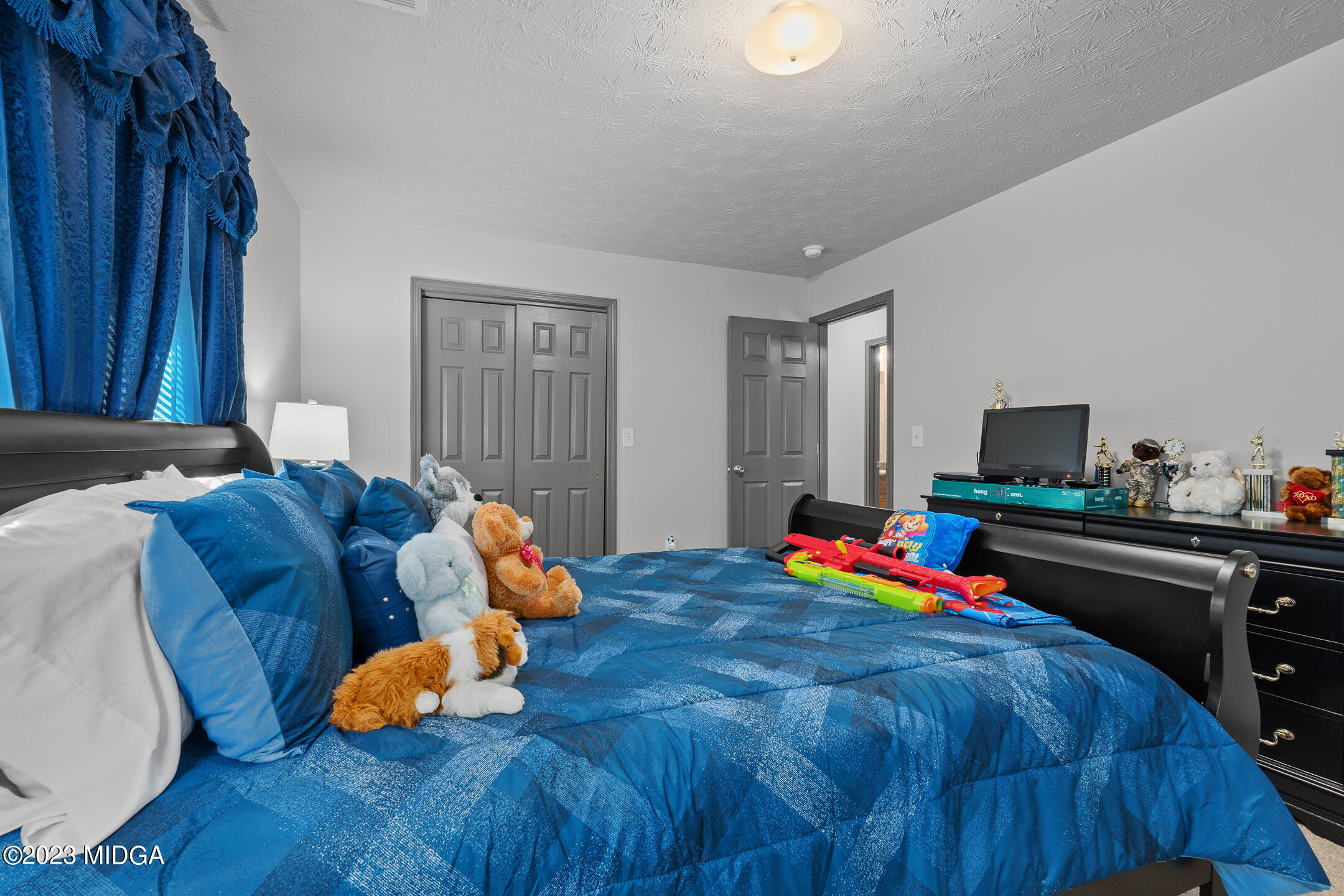 128 Samuel Barber Road Jackson, GA 30233 - Photo 24 of 27 a living room with furniture and a flat screen tv