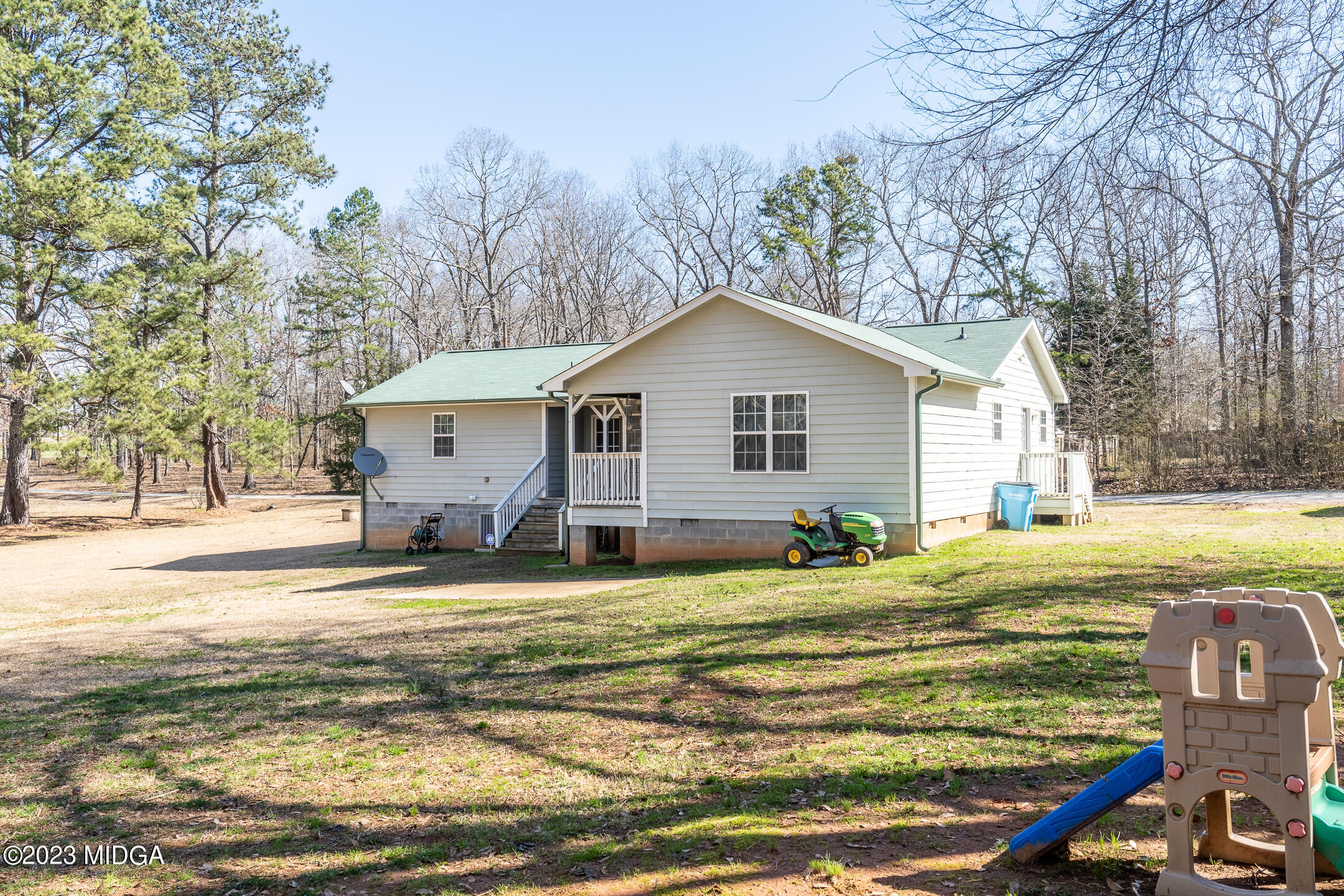 128 Samuel Barber Road Jackson, GA 30233 - Photo 26 of 27 a view of a house with a yard and sitting area