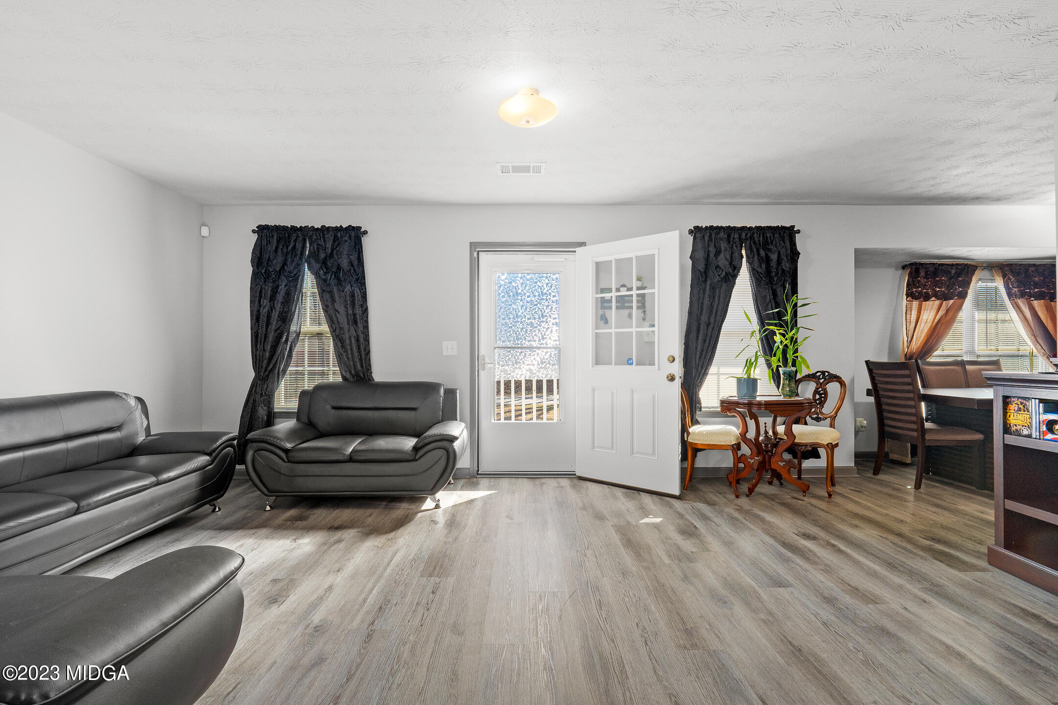 128 Samuel Barber Road Jackson, GA 30233 - Photo 6 of 27 a living room with furniture and a wooden floor