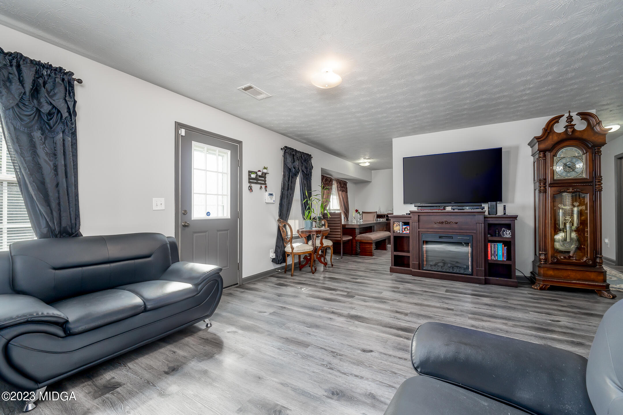 128 Samuel Barber Road Jackson, GA 30233 - Photo 8 of 27 a living room with furniture and a flat screen tv