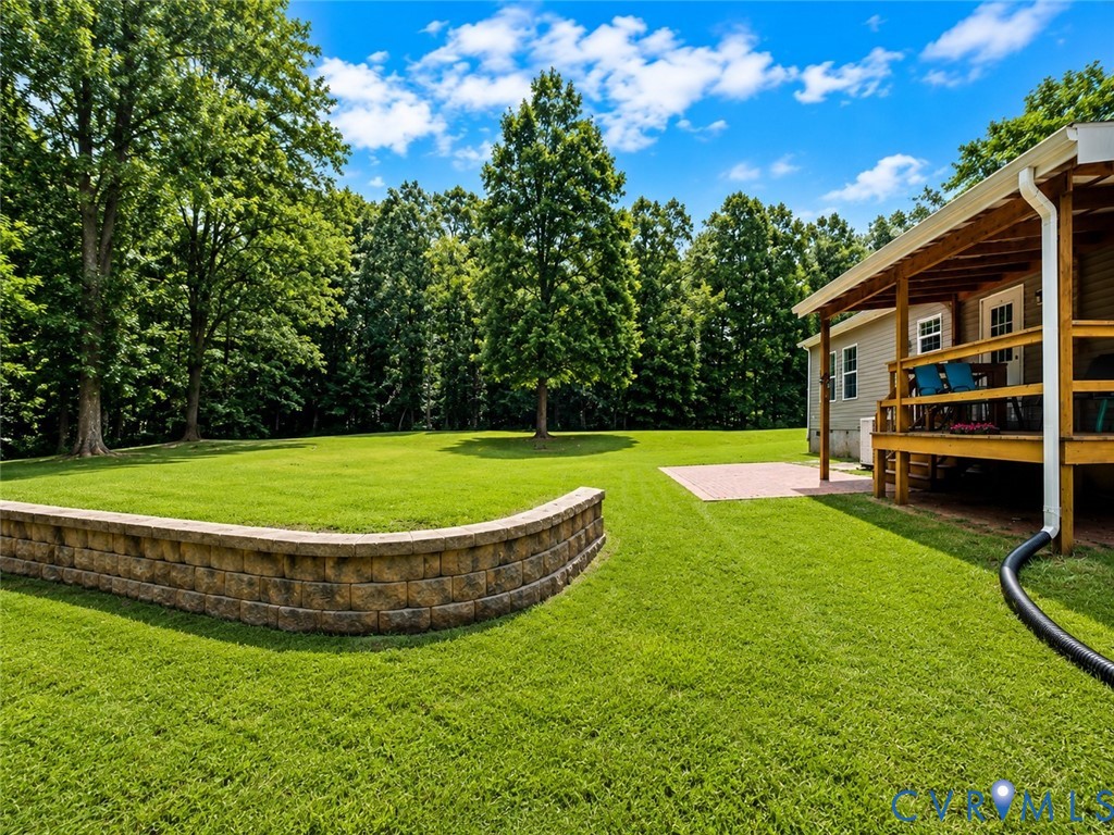1927 Five Forks Road Pamplin, VA 23958 - Photo 5 of 30 Expansive green lawn with a retaining wall, shaded