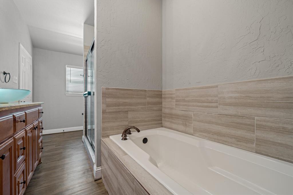 337 County Road 2719 Mabank, TX 75147 - Photo 10 of 19 a bathroom with a bathtub and a shower