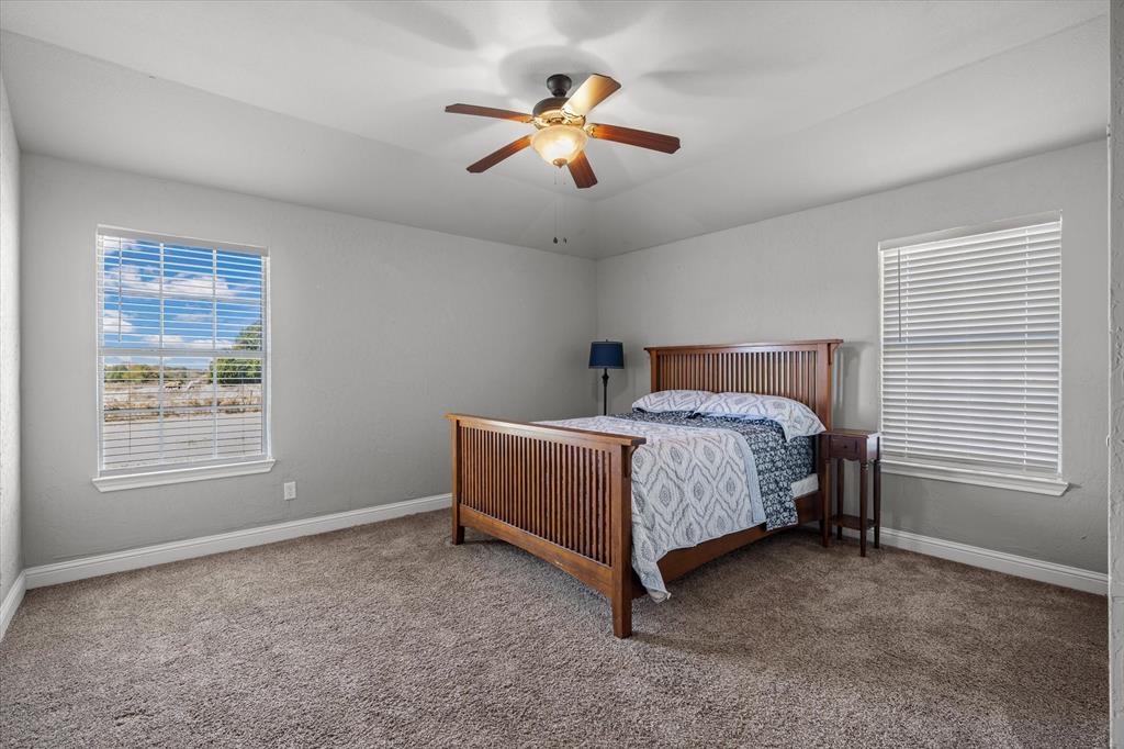 337 County Road 2719 Mabank, TX 75147 - Photo 13 of 19 a bedroom with a bed and a ceiling fan