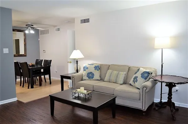 a living room with furniture and a lamp