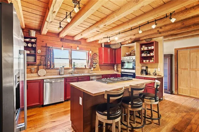 a kitchen with sink a window and cabinets
