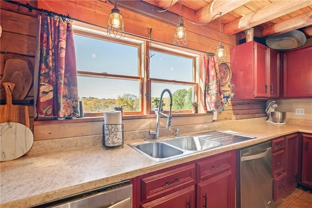 a room with stainless steel appliances kitchen island granite countertop a refrigerator and a stove top oven
