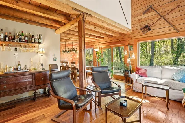 a living room with furniture and a floor to ceiling window