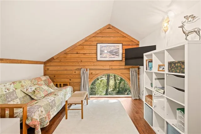 a hallway with sliding door and wooden floor