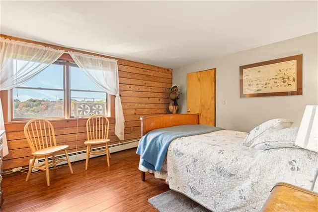 a living room with stainless steel appliances granite countertop furniture and a wooden floor