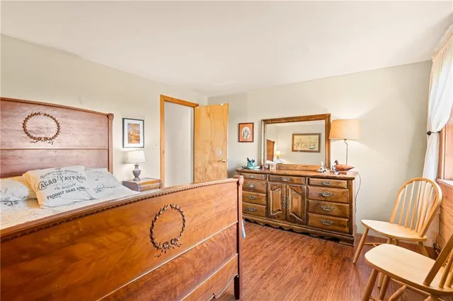 a bedroom with a bed and two windows