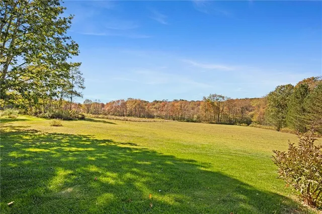 a view of ocean with green space