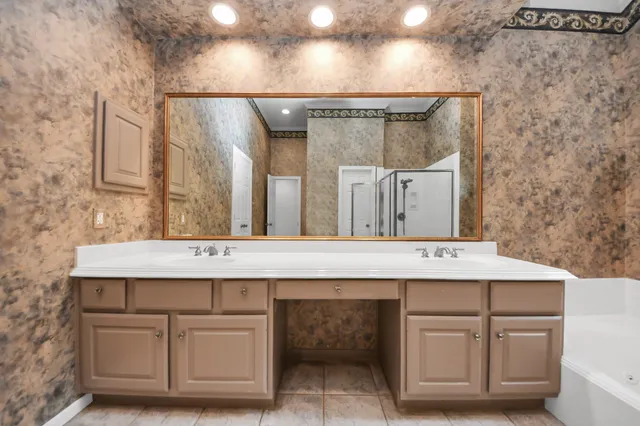 a view of a bathroom with a sink and a mirror
