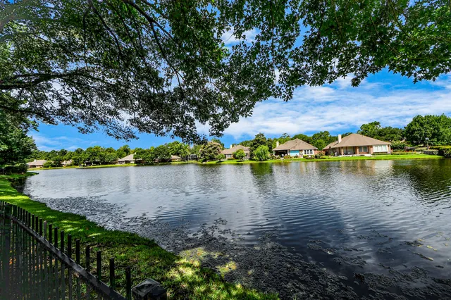 a view of a lake with houses in the back