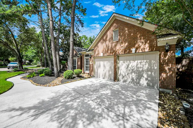 a view of a house with a yard and potted plants