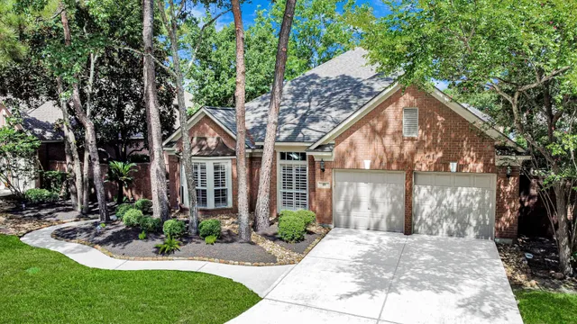 a front view of a house with a yard and potted plants