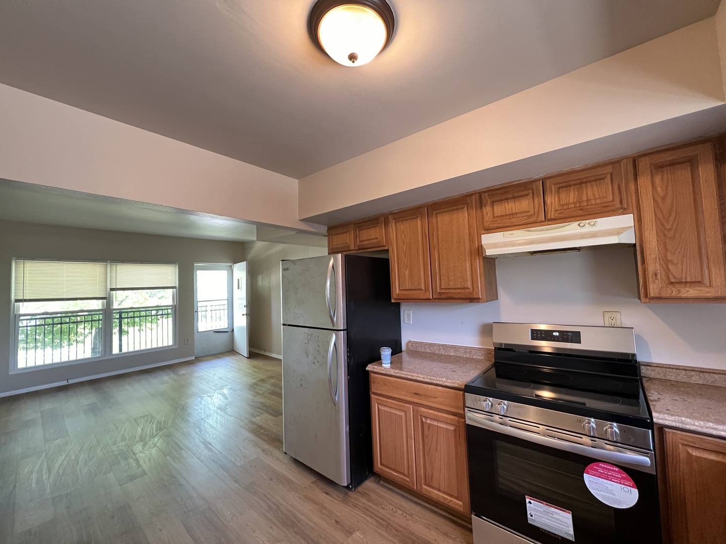2900 Elizabeth Avenue, Unit 2S Zion, IL 60099 - Photo 2 of 12 a kitchen with granite countertop a stove a sink dishwasher and a refrigerator with wooden floor