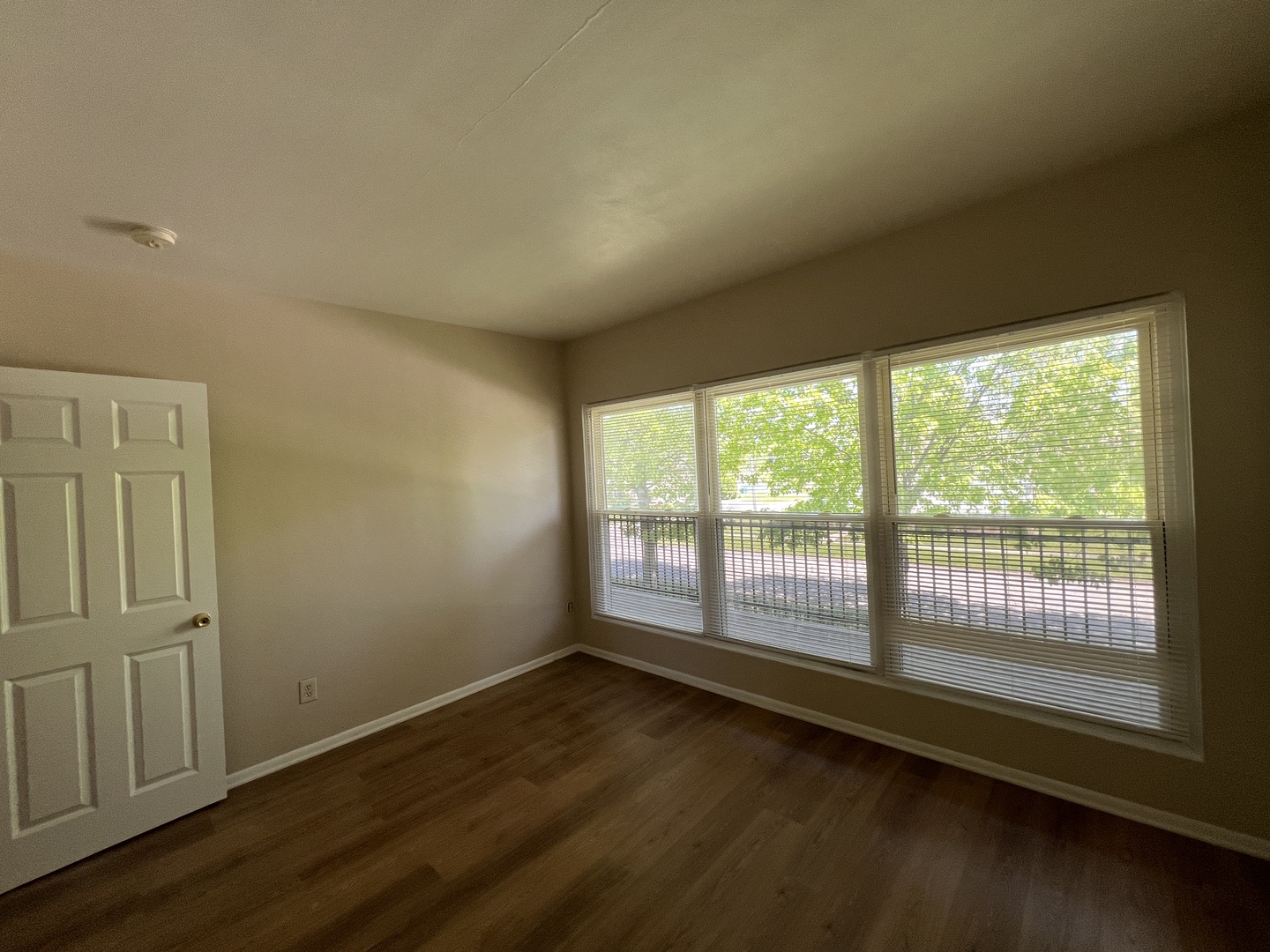 2900 Elizabeth Avenue, Unit 2S Zion, IL 60099 - Photo 7 of 12 wooden floor in an empty room with a window