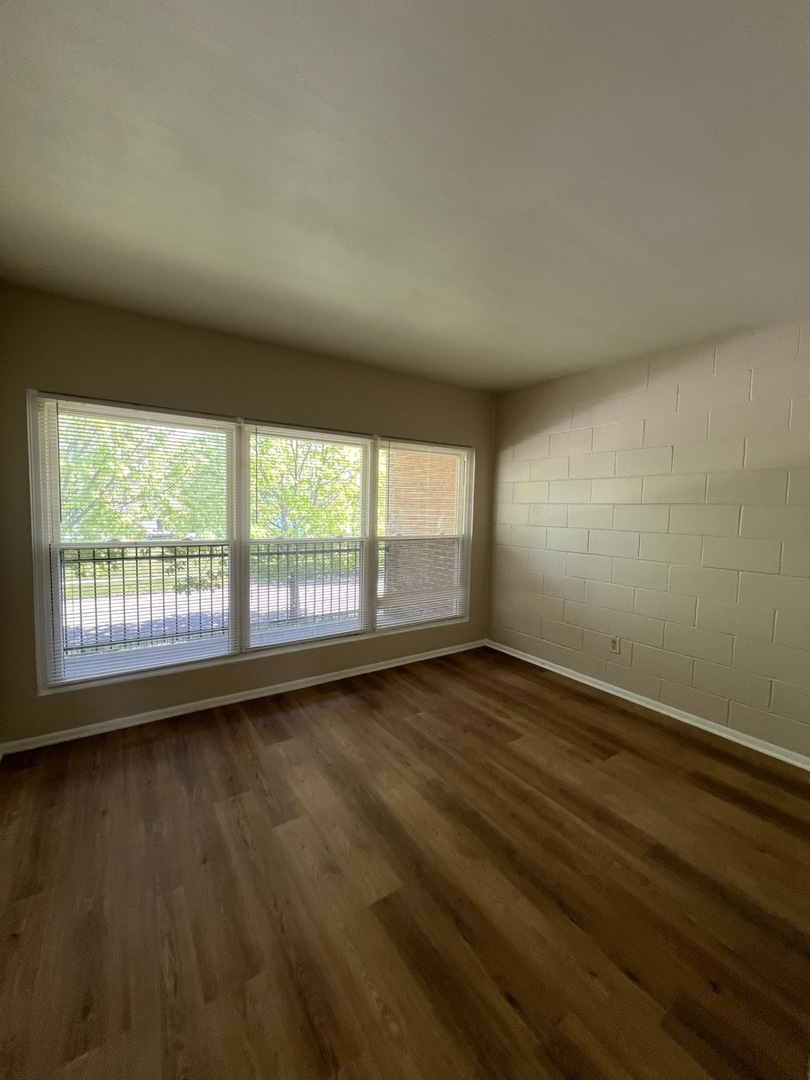 2900 Elizabeth Avenue, Unit 2S Zion, IL 60099 - Photo 9 of 12 wooden floor in an empty room with a window