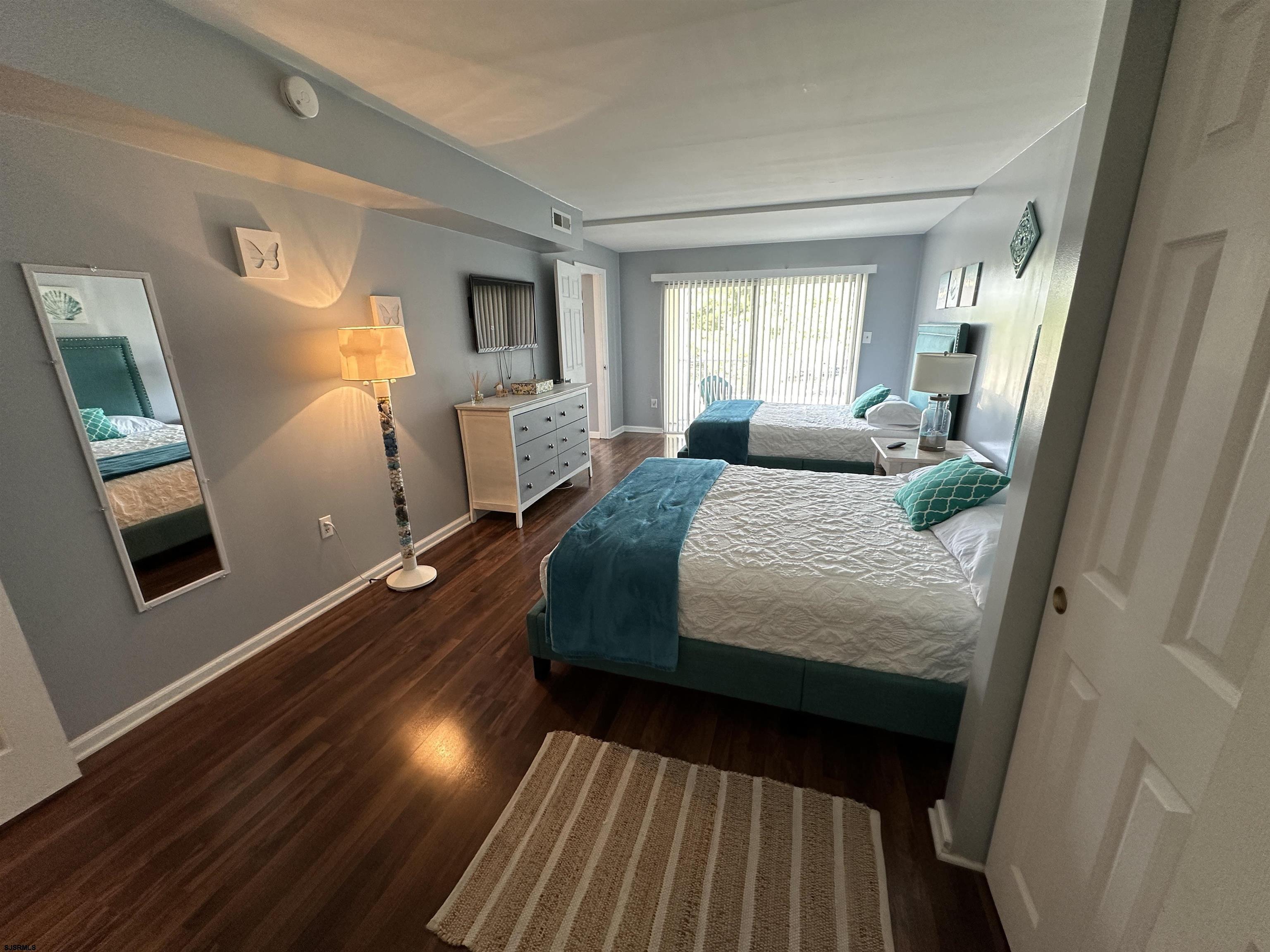 4600 West Brigantine Avenue, Unit 211 Brigantine, NJ 08203 - Photo 14 of 23 a bedroom with a bed and wooden floor